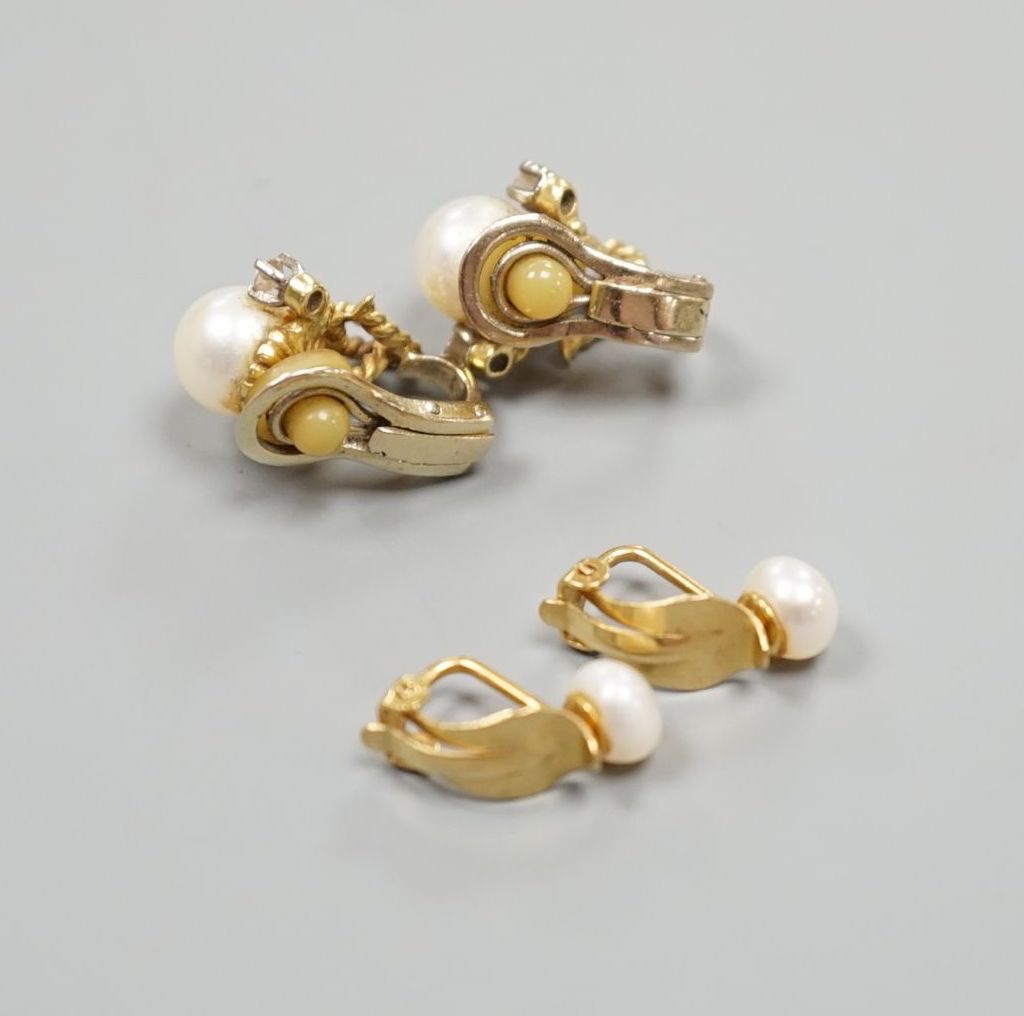 A pair of 20th century yellow metal, diamond and cultured pearl set ear clips, 18mm and a pair of yellow metal and cultured pearl set ear clips, gross 10.3 grams.